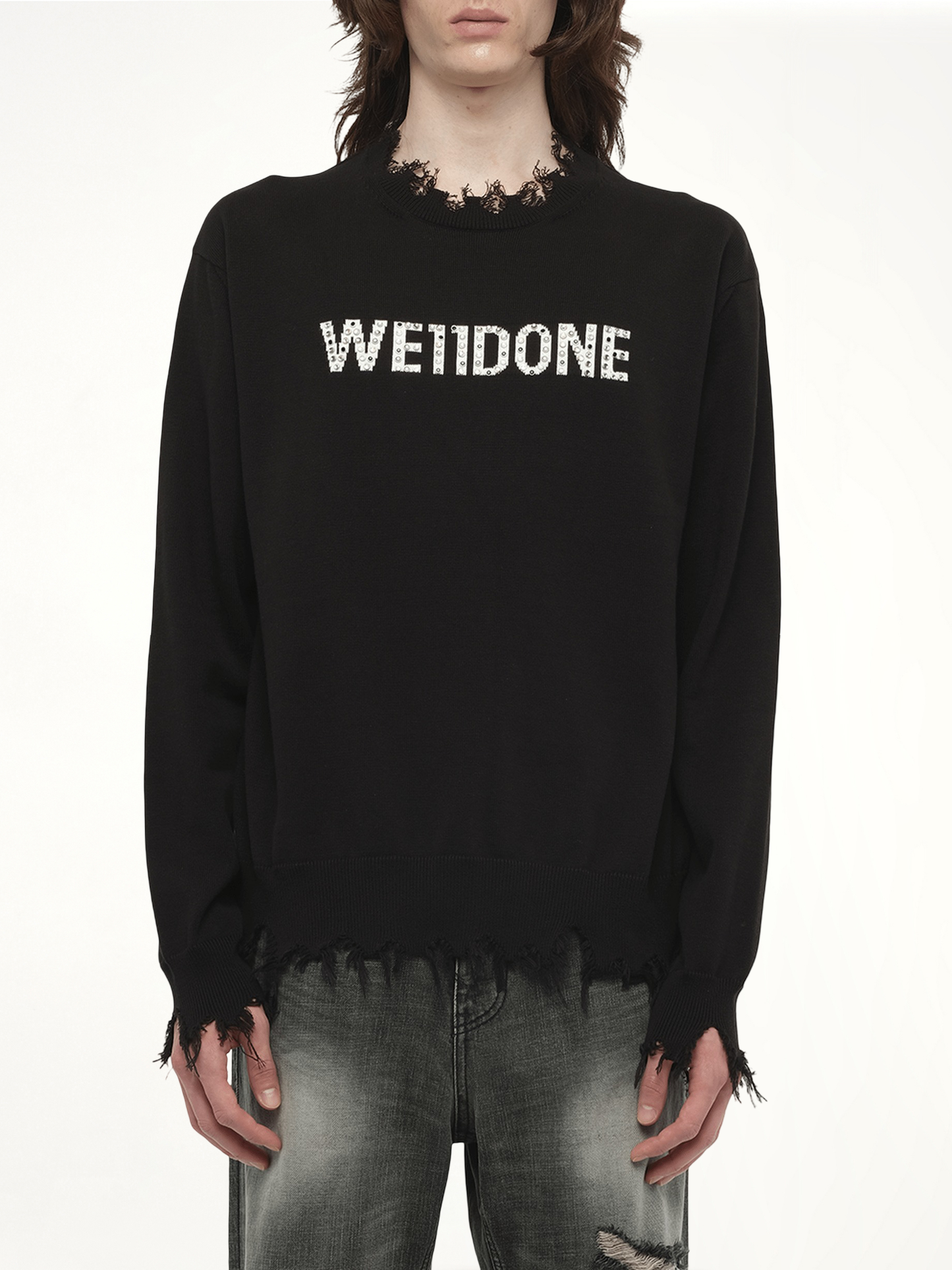 Image of a model wearing Outerwear. Productname: WE11DONE Grunge Rhinestone Logo Sweater in Black colour by brand - WE11DONE