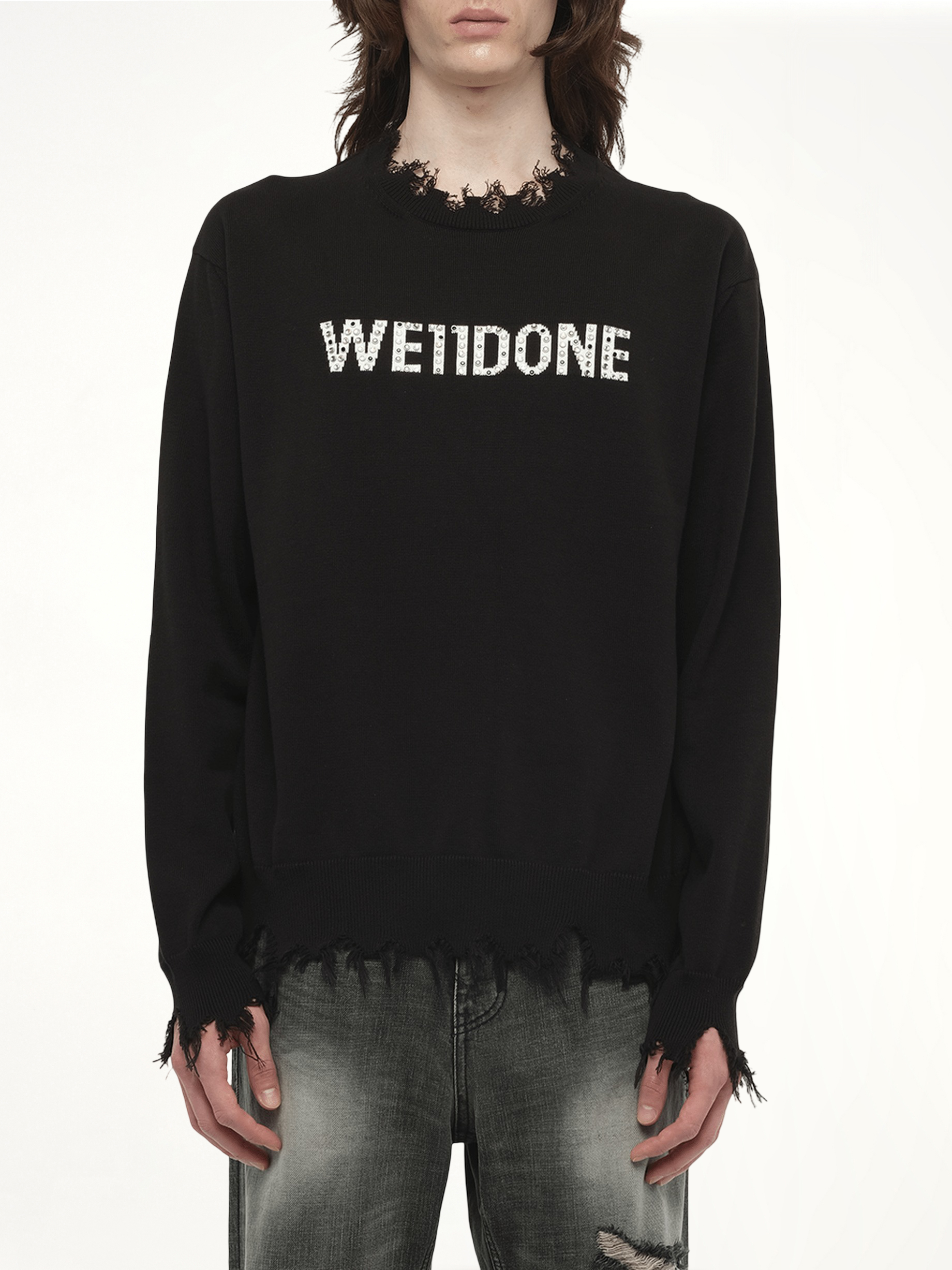 Image of a model wearing Outerwear. Productname: WE11DONE Grunge Rhinestone Logo Sweater in Black colour by brand - WE11DONE