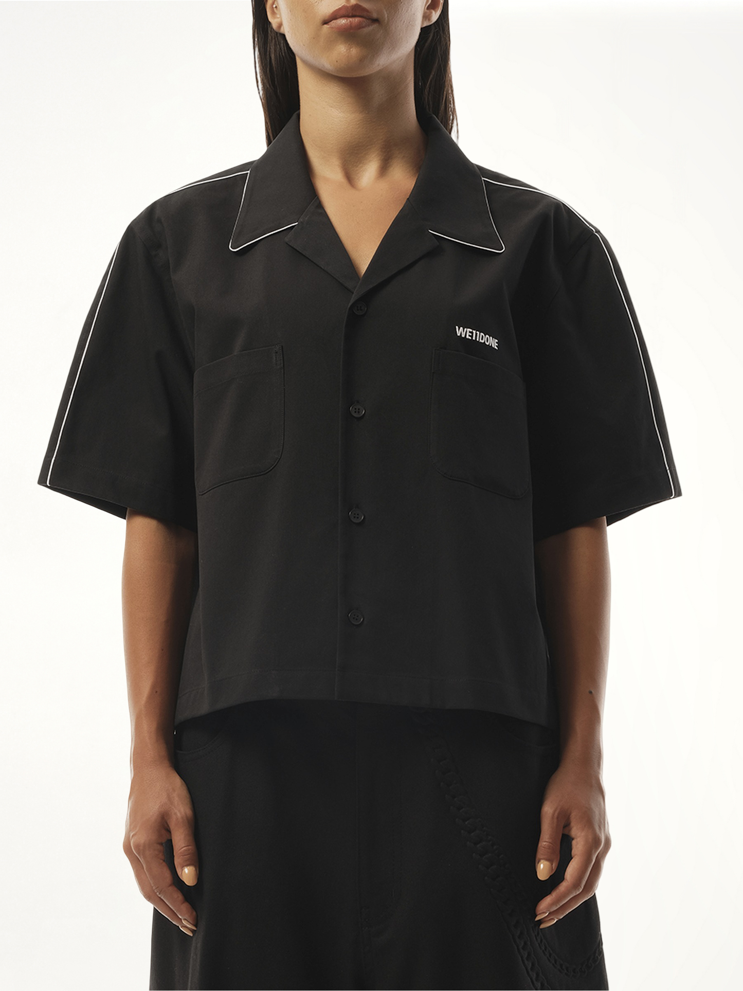 Image of a model wearing Shorts. Productname: WE11DONE Short-Sleeved Convertible Shirt in Black colour by brand - WE11DONE