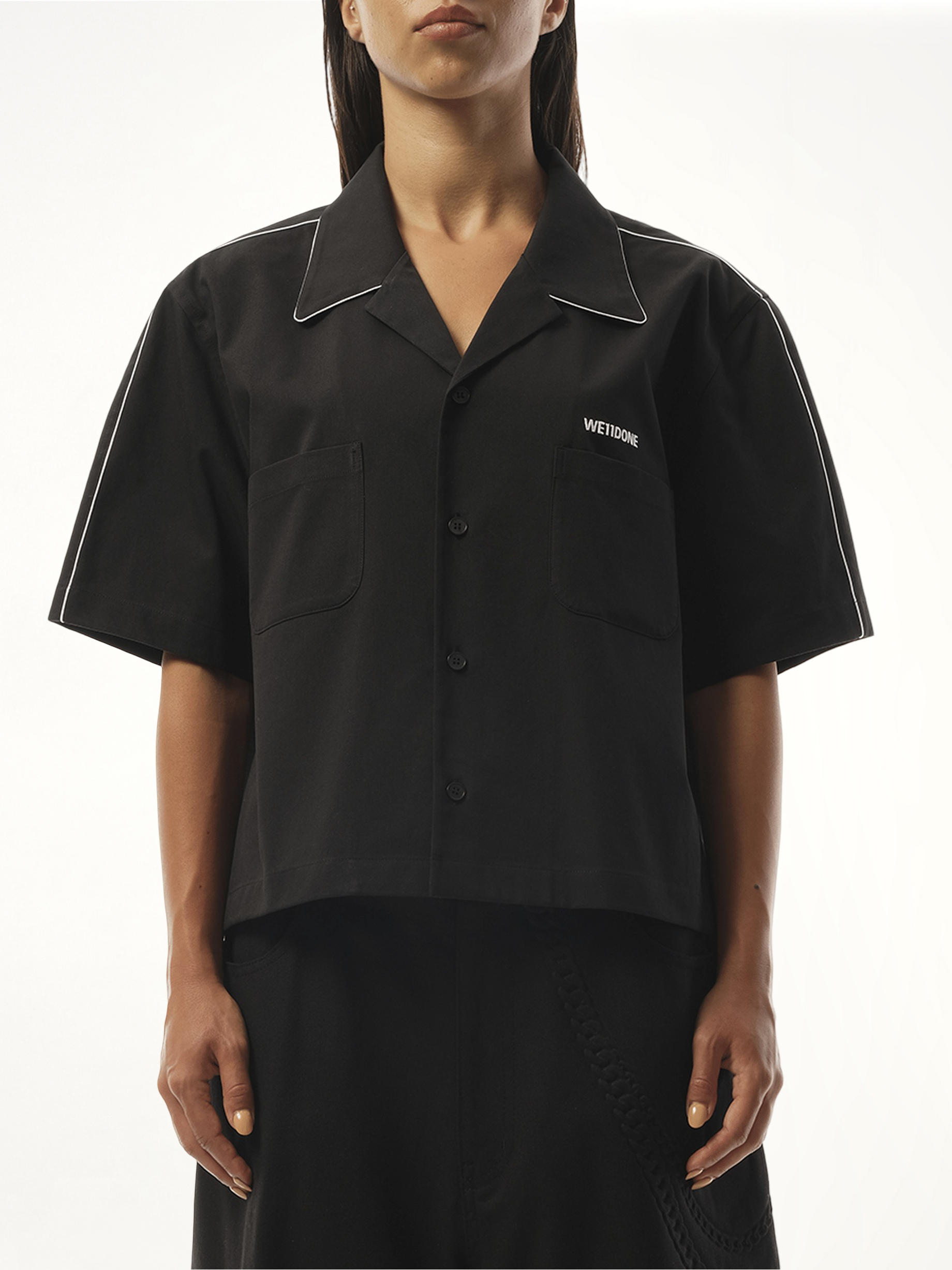 Image of a model wearing Shorts. Productname: WE11DONE Short-Sleeved Convertible Shirt in Black colour by brand - WE11DONE