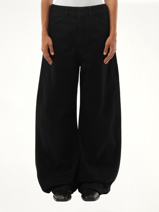 Image of a model wearing Denim. Productname: LEMAIRE High Waisted Curved Denim Pants in Black colour by brand - LEMAIRE