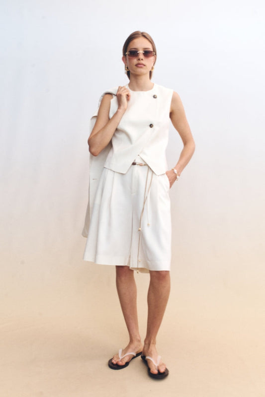 Image of a model wearing Tops. Product name - Junia Vest Ivory in Ivory colour by brand - Blanca Studio