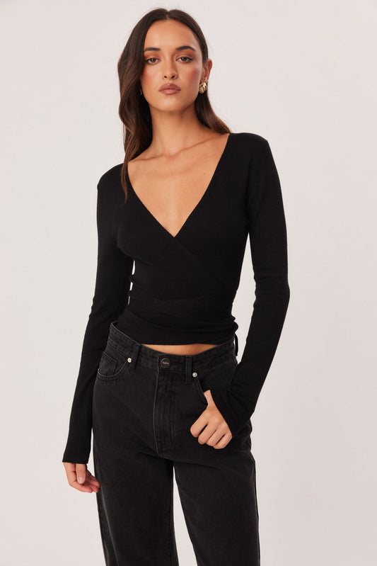 Image of a model wearing Tops. Productname: SNDYS NIKOLA WRAP TOP in Black colour by brand - SNDYS