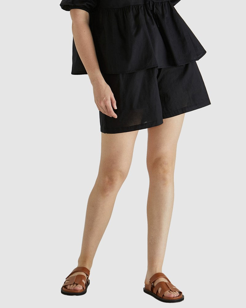 Image of a model wearing Shorts. Product name - Rumi Short Black in Black colour by brand - Sass Clothing