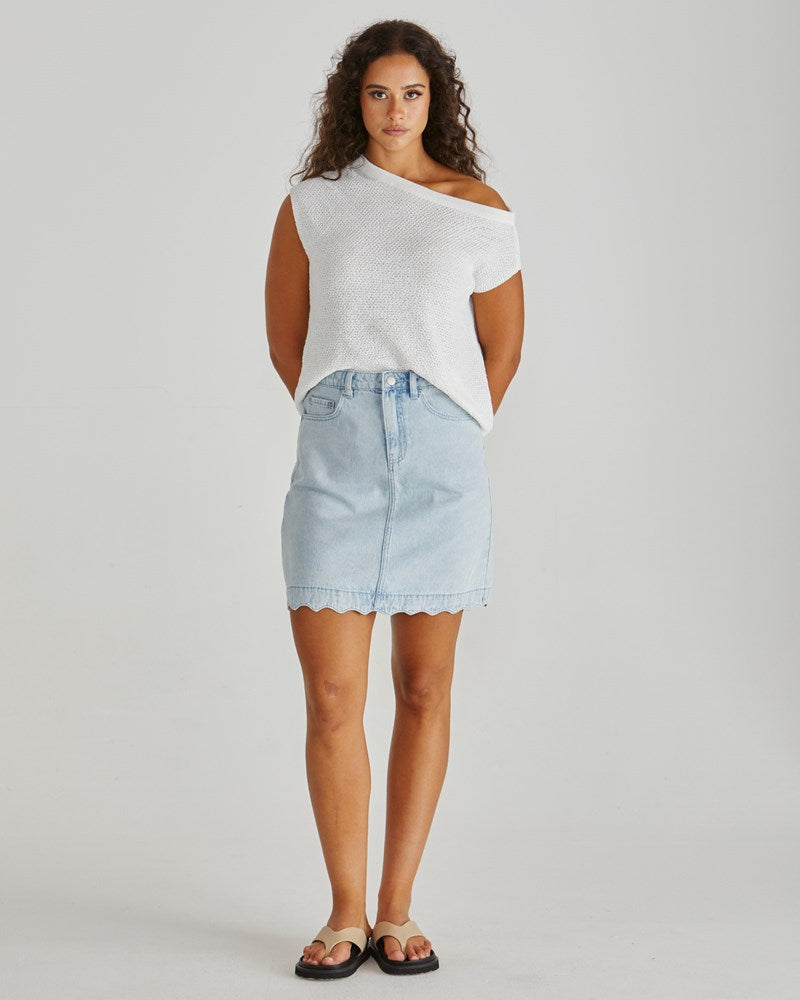 Image of a model wearing Skirts. Product name - Vale Scalloped Denim Skirt Bleach in Bleach colour by brand - Sass Clothing