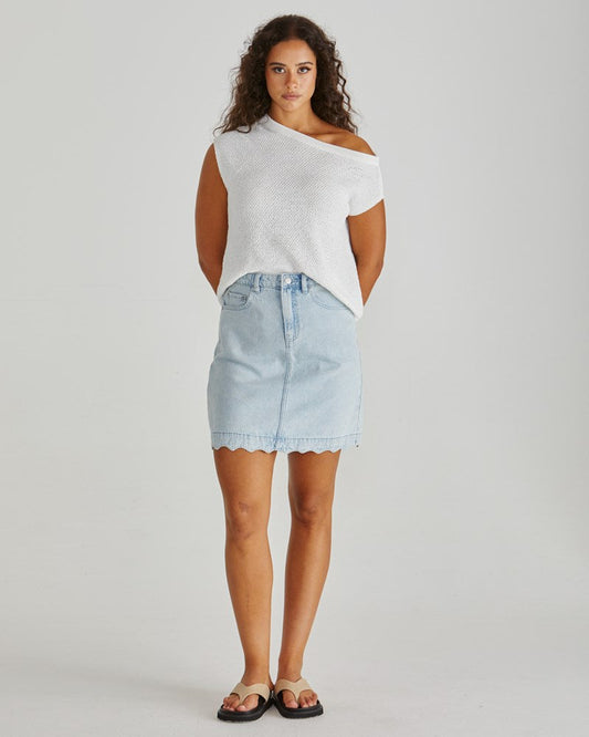 Image of a model wearing Skirts. Product name - Vale Scalloped Denim Skirt Bleach in Bleach colour by brand - Sass Clothing