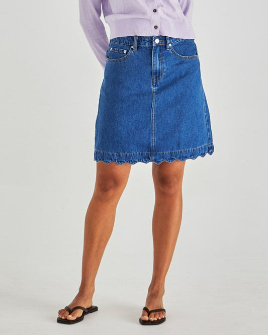 Image of a model wearing Skirts. Product name - Vale Scalloped Denim Skirt Mid Blue Wash in Mid Blue Wash colour by brand - Sass Clothing