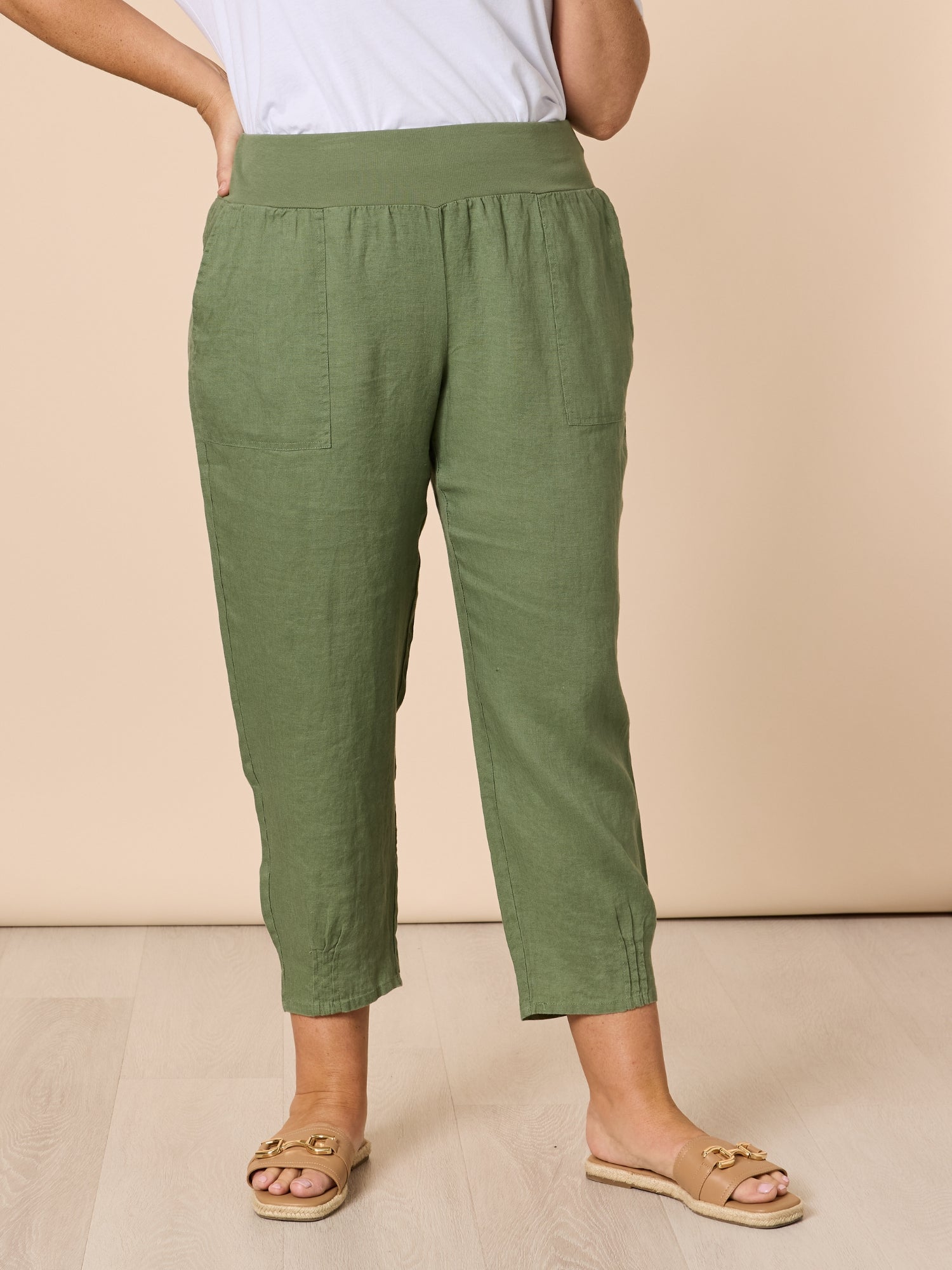 Image of a model wearing Pants. Product name - Sarah Linen Pleat Hem Pant Khaki in Khaki colour by brand - Gordon Smith