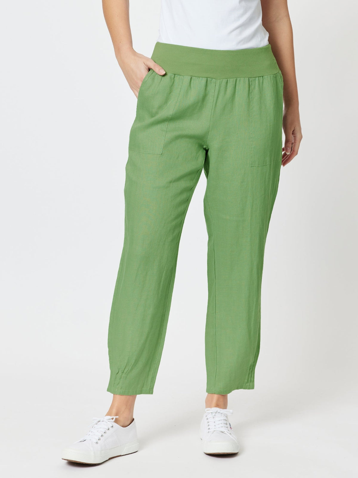Image of a model wearing Pants. Product name - Sarah Linen Pleat Hem Pant Fern in Fern colour by brand - Gordon Smith