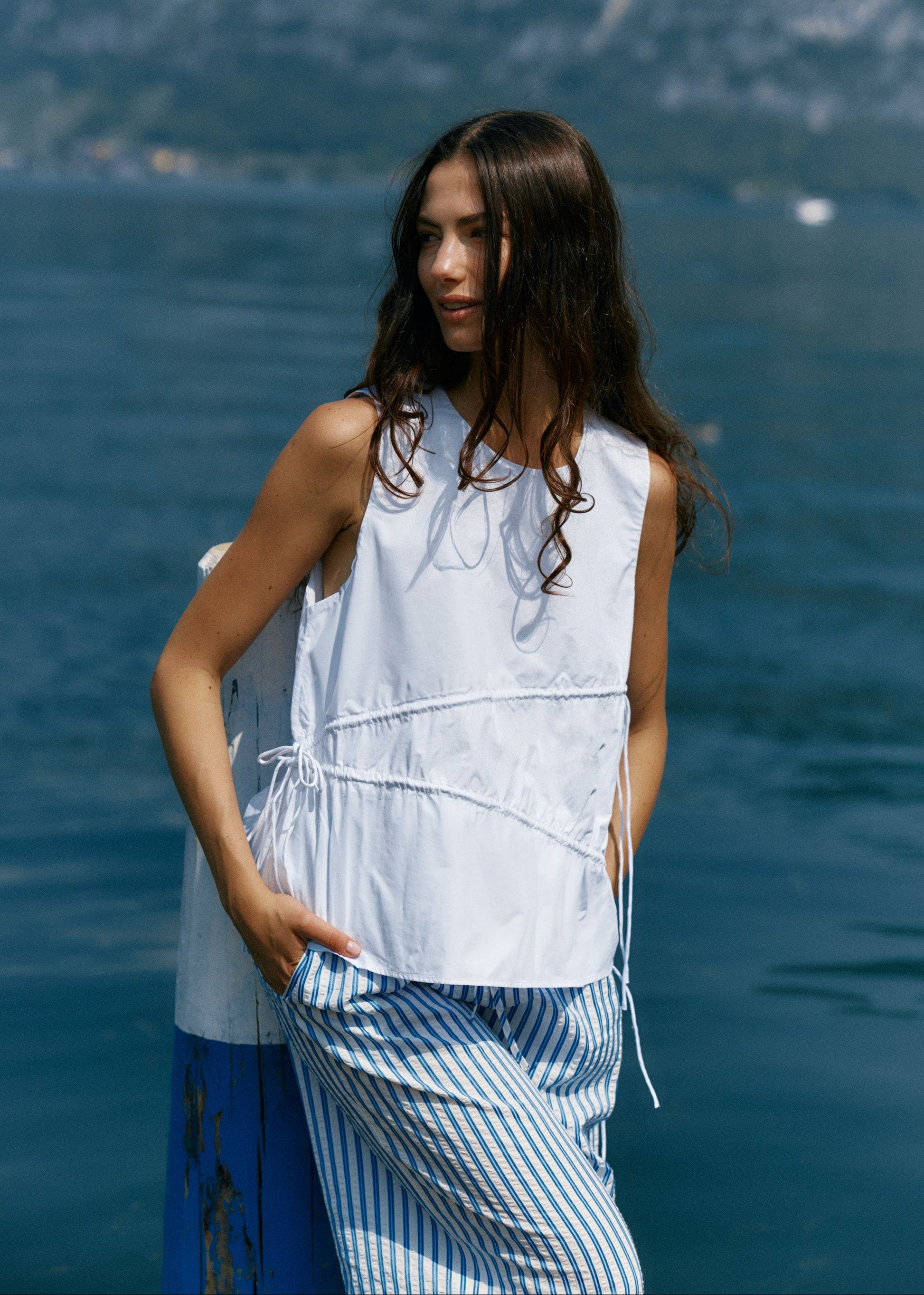 Image of a model wearing Tops. Product name - Elin Gathered Tie Top White in White colour by brand - Sass Clothing