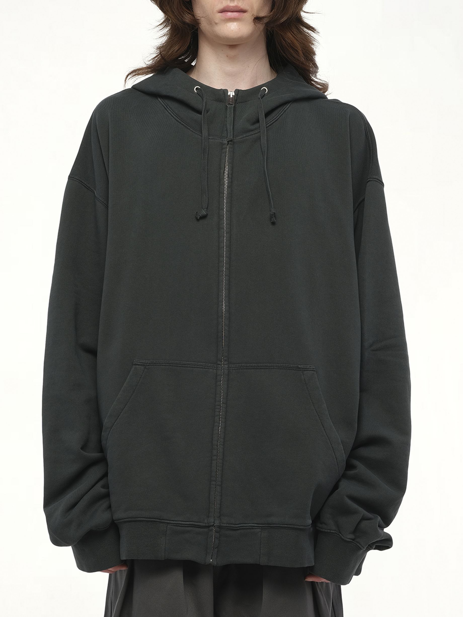 Image of a model wearing Outerwear. Product name - Number Zip Logo Hoodie in Black colour by brand - MAISON MARGIELA