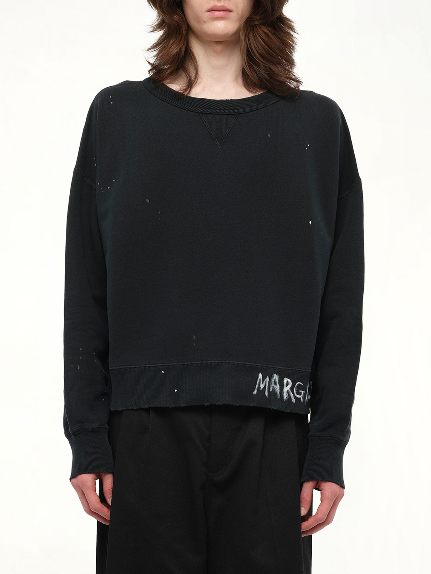 Image of a model wearing Outerwear. Product name - Margiela Sweatshirt in Black colour by brand - MAISON MARGIELA