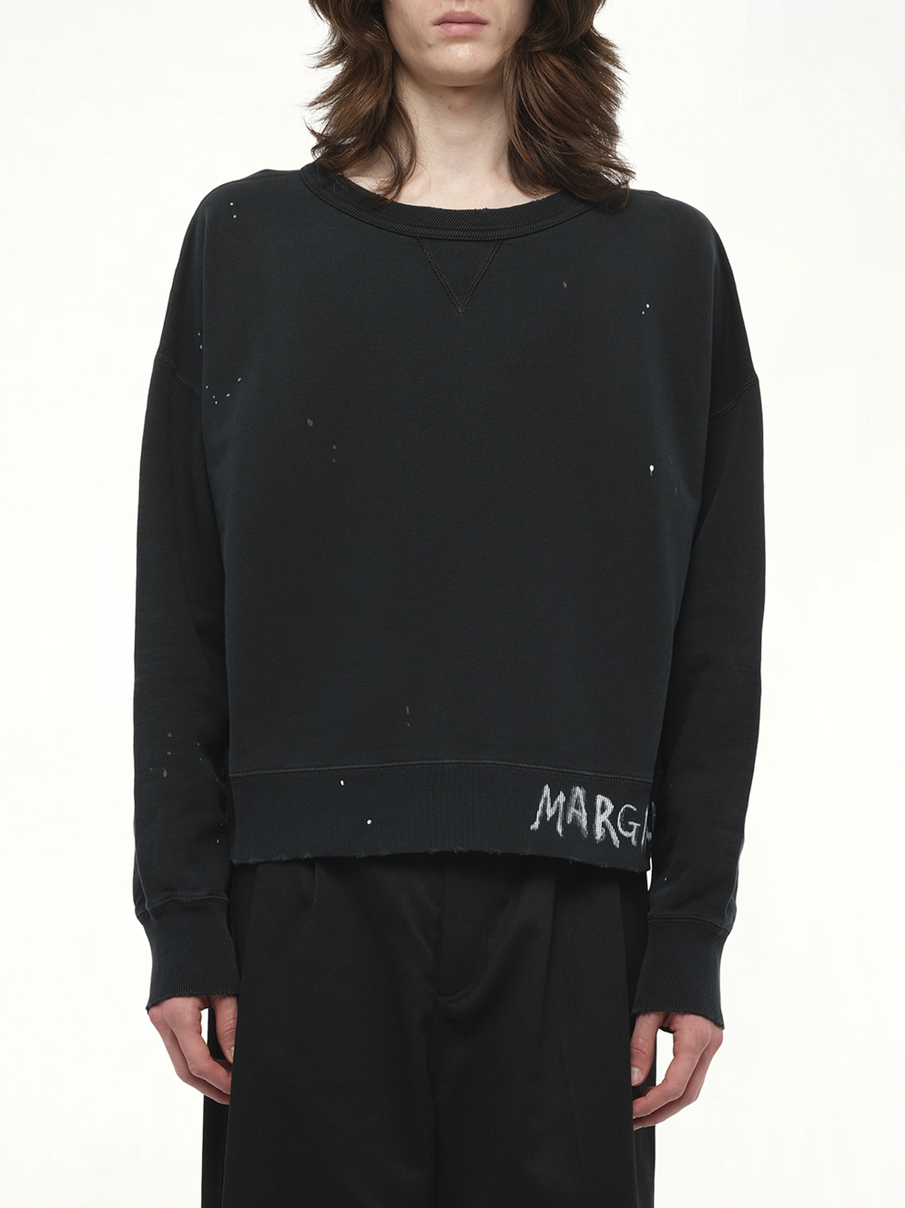 Image of a model wearing Outerwear. Product name - Margiela Sweatshirt in Black colour by brand - MAISON MARGIELA