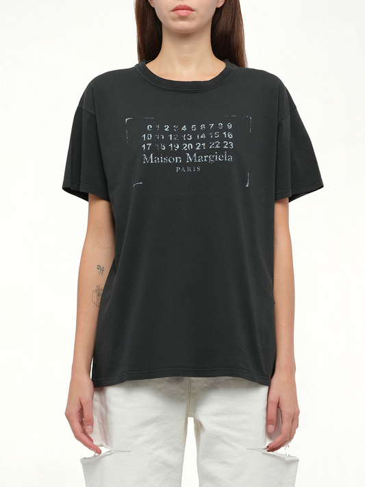 Image of a model wearing Tops. Productname: MAISON MARGIELA Logo T-Shirt in BLACK colour by brand - MAISON MARGIELA