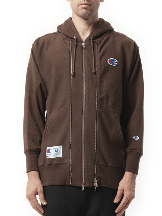 Image of a model wearing Outerwear. Productname: UNDERCOVER Undercover x Champion Zip Hoodie in BROWN colour by brand - UNDERCOVER