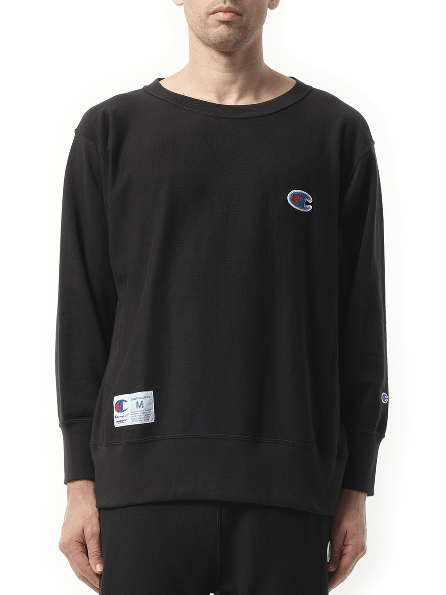 Image of a model wearing Outerwear. Product name - Undercover x Champion Sweatshirt in Black colour by brand - UNDERCOVER