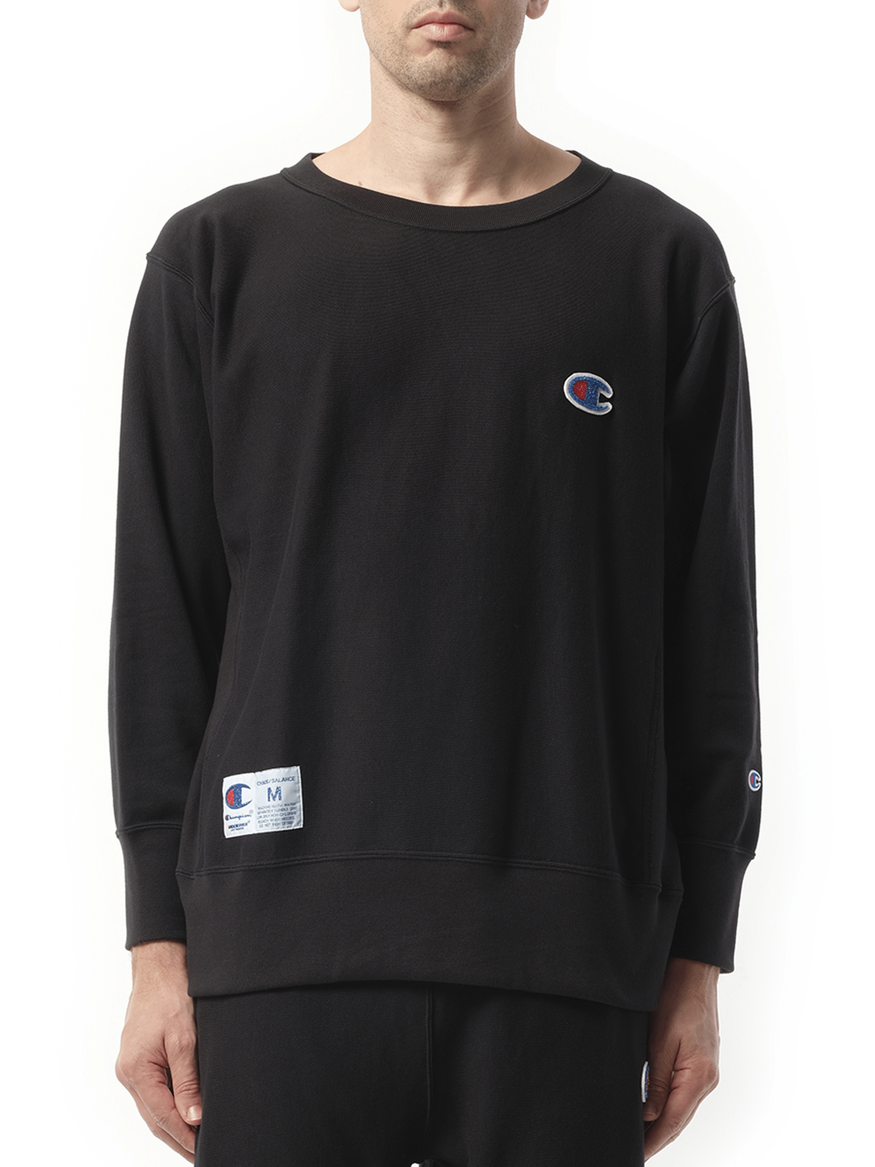 Image of a model wearing Outerwear. Product name - Undercover x Champion Sweatshirt in Black colour by brand - UNDERCOVER