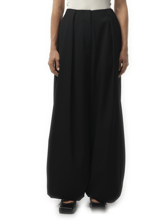 Image of a model wearing Pants. Productname: JACQUEMUS Le Pantalon Calisson in Black colour by brand - JACQUEMUS