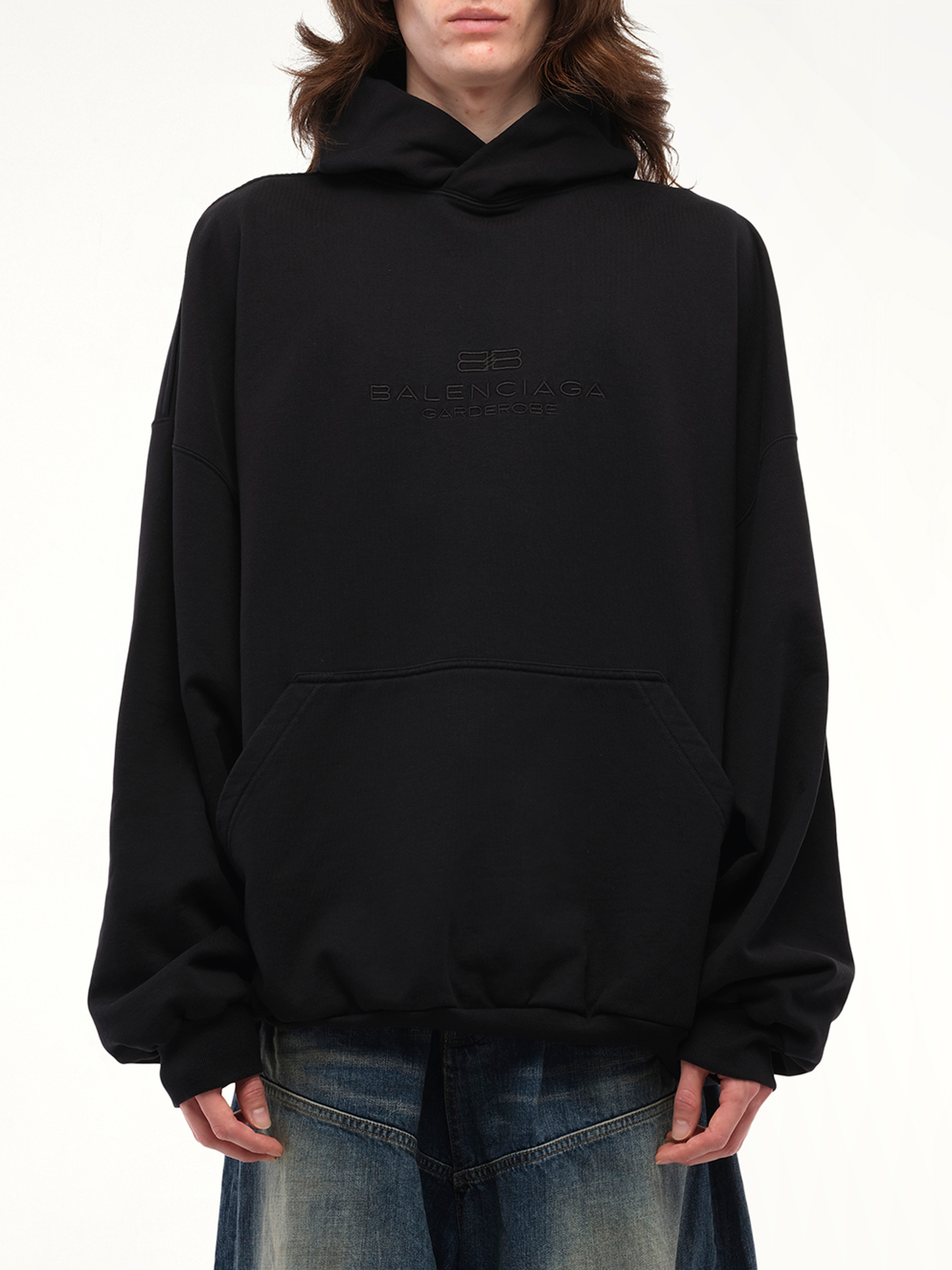 Image of a model wearing Outerwear. Productname: BALENCIAGA BB Embroidery Large Fit Hoodie in Black colour by brand - BALENCIAGA
