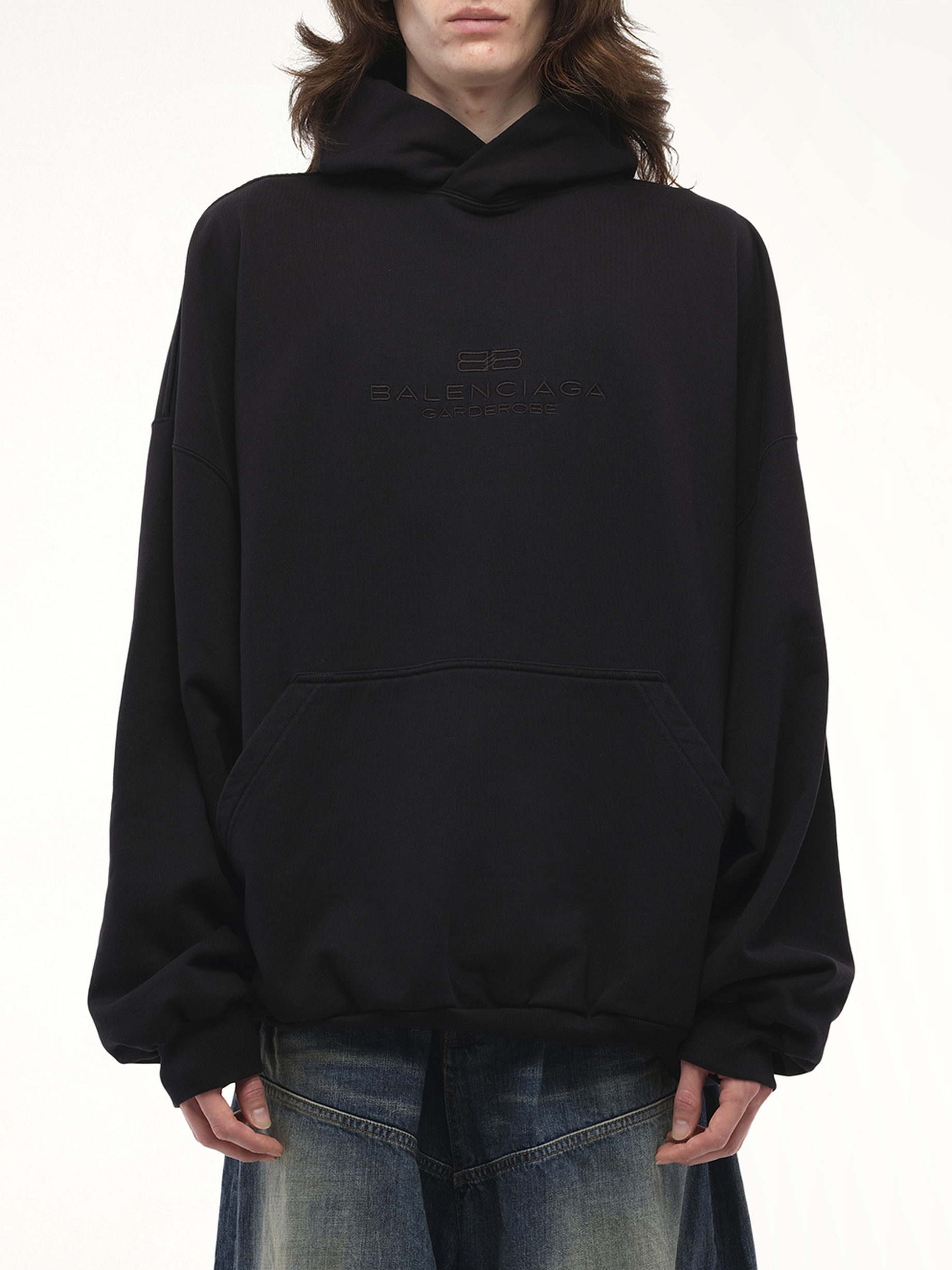 Image of a model wearing Outerwear. Productname: BALENCIAGA BB Embroidery Large Fit Hoodie in Black colour by brand - BALENCIAGA