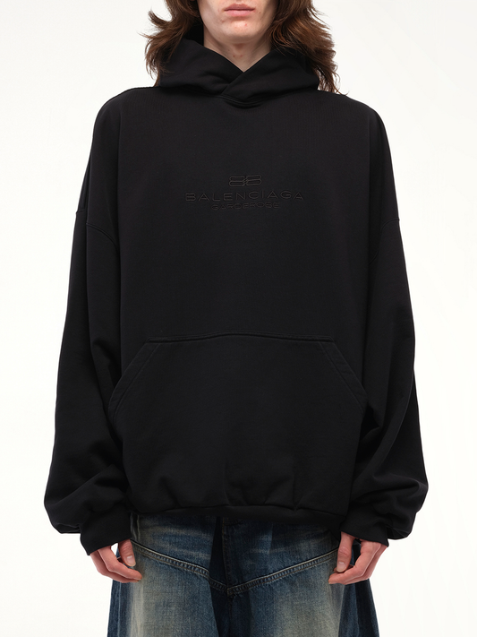 Image of a model wearing Outerwear. Productname: BALENCIAGA BB Embroidery Large Fit Hoodie in Black colour by brand - BALENCIAGA