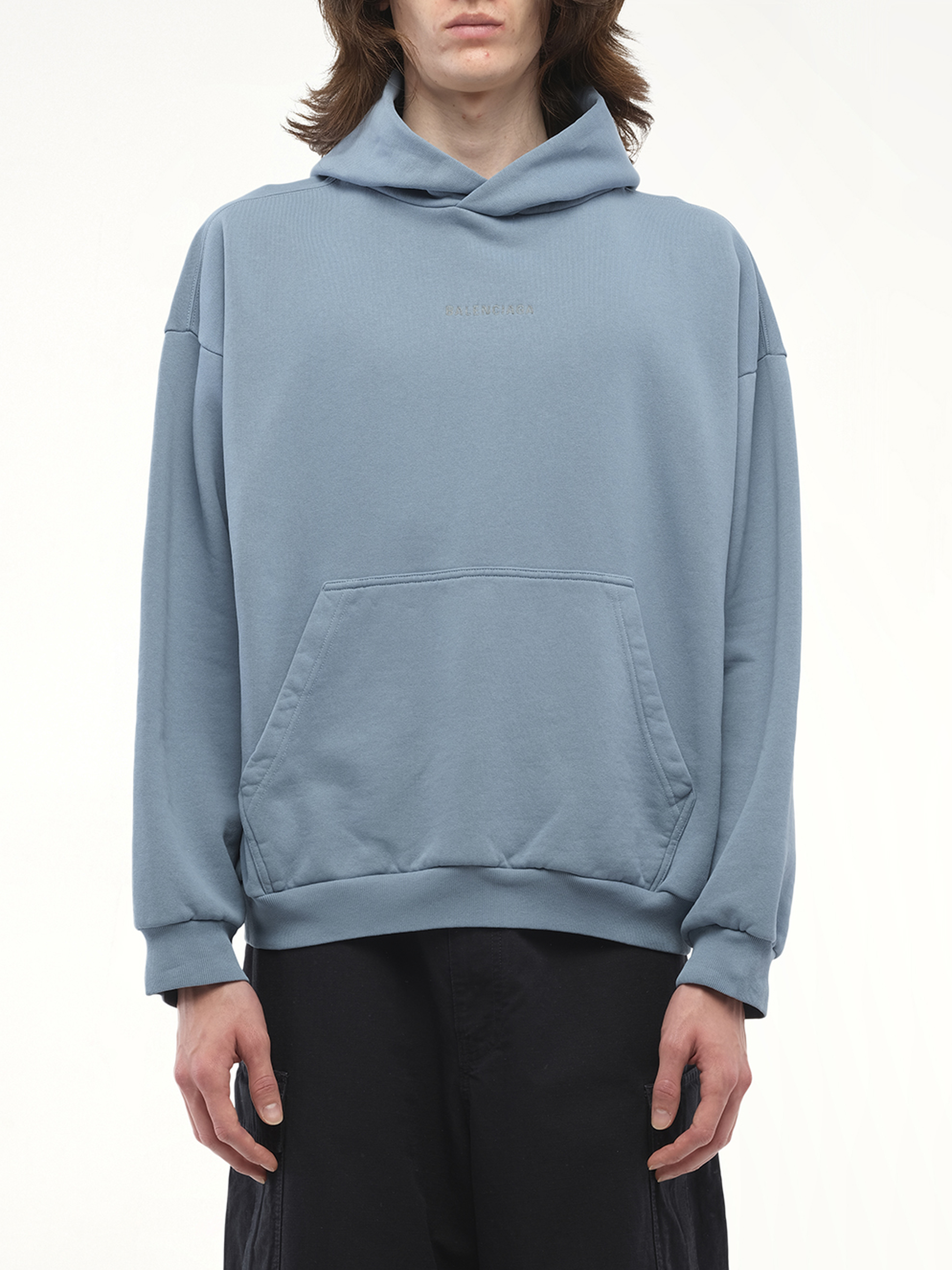 Image of a model wearing Outerwear. Productname: BALENCIAGA Reflective Logo Medium Fit Hoodie in Grey colour by brand - BALENCIAGA
