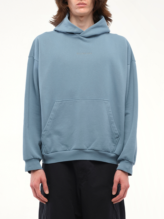 Image of a model wearing Outerwear. Productname: BALENCIAGA Reflective Logo Medium Fit Hoodie in Grey colour by brand - BALENCIAGA