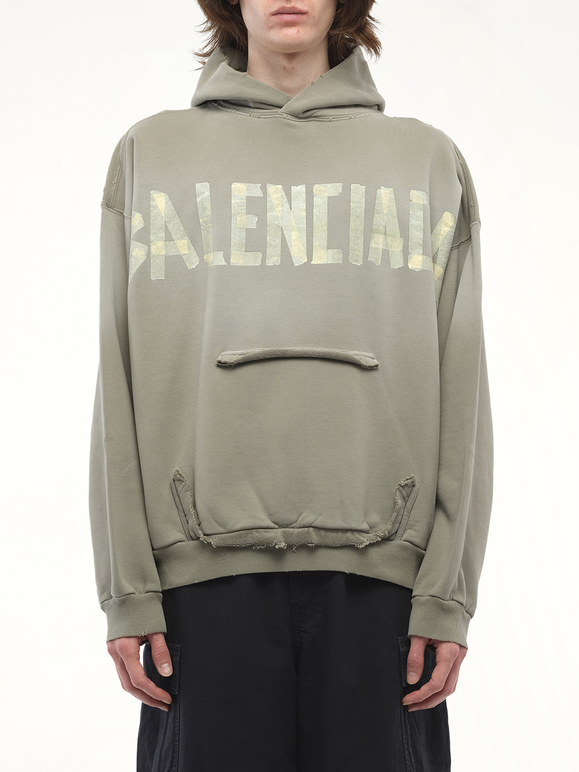 Image of a model wearing Outerwear. Productname: BALENCIAGA Tape Type Ripped Pocket Hoodie in Green colour by brand - BALENCIAGA