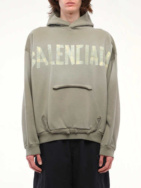 Image of a model wearing Outerwear. Productname: BALENCIAGA Tape Type Ripped Pocket Hoodie in Green colour by brand - BALENCIAGA