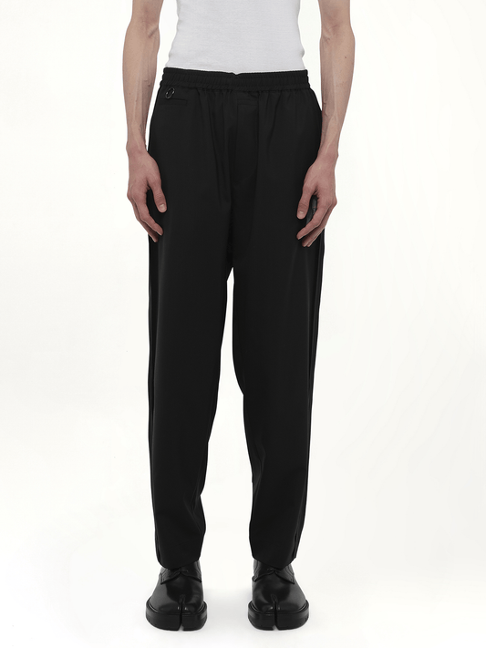 Image of a model wearing Pants. Productname: UNDERCOVER Chaos Balance Casual Pants in BLACK colour by brand - UNDERCOVER