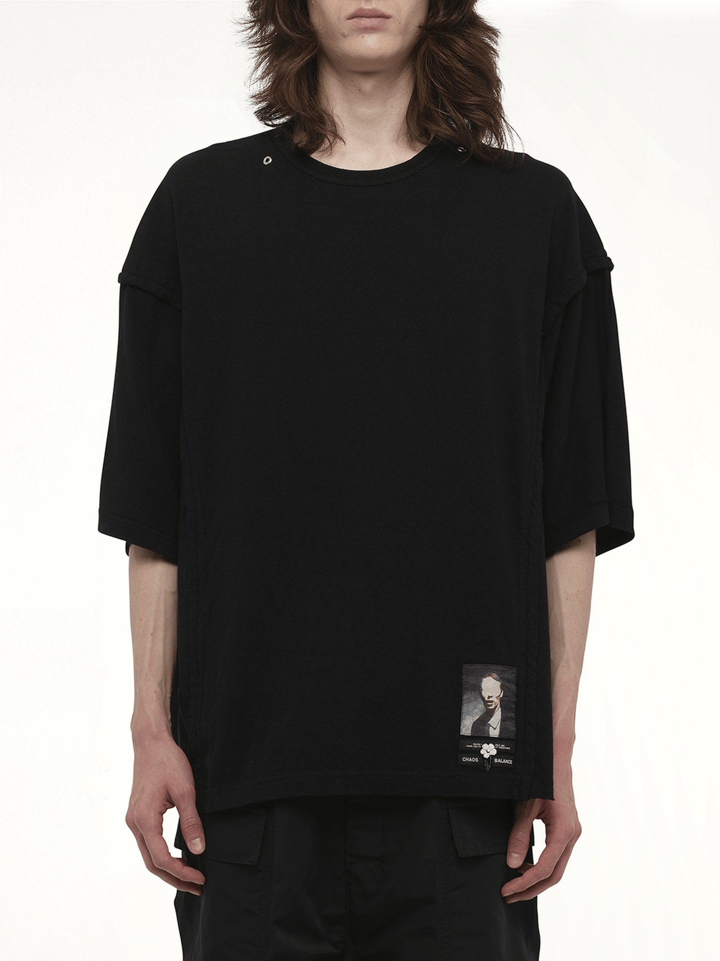 Image of a model wearing Tops. Productname: UNDERCOVER Chaos Balance T-Shirt in BLACK colour by brand - UNDERCOVER