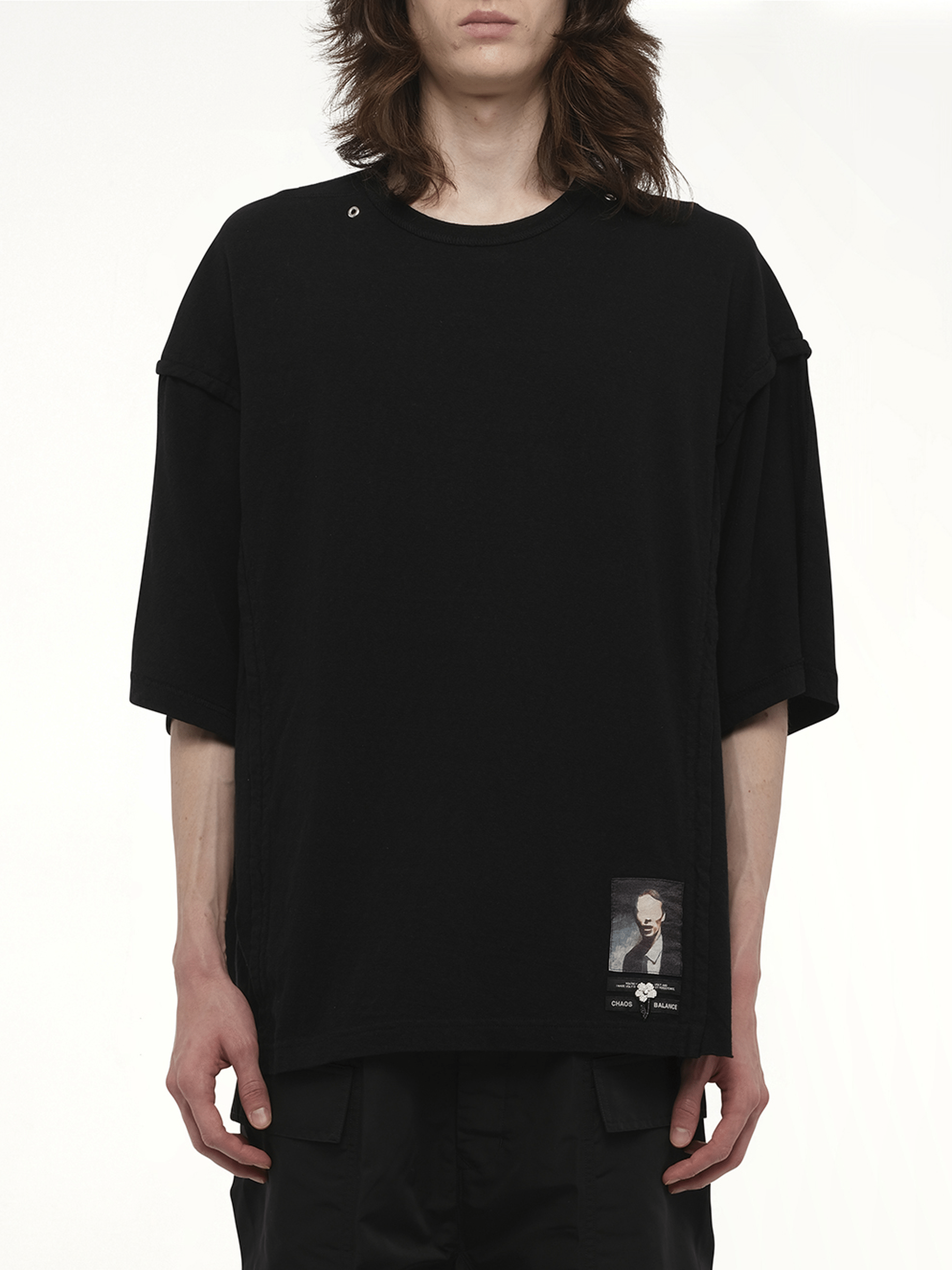 Image of a model wearing Tops. Productname: UNDERCOVER Chaos Balance T-Shirt in BLACK colour by brand - UNDERCOVER