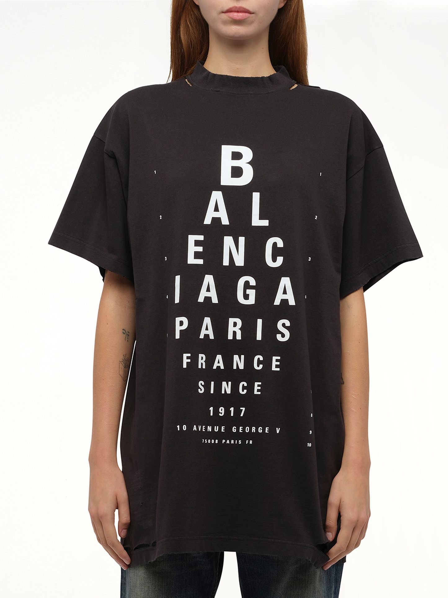 Image of a model wearing Tops. Productname: BALENCIAGA Eye-Test Oversized T-Shirt in Black colour by brand - BALENCIAGA