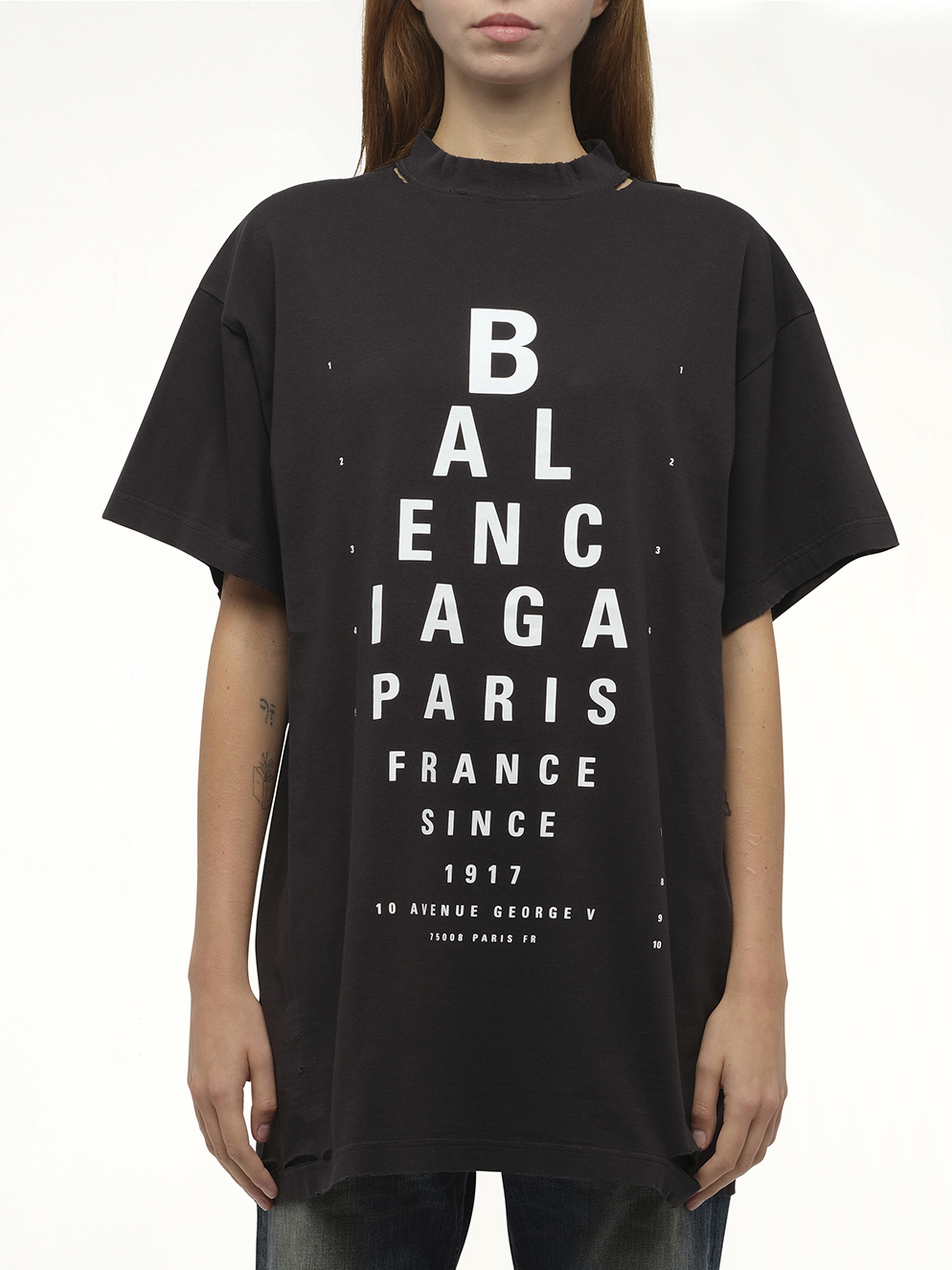 Image of a model wearing Tops. Productname: BALENCIAGA Eye-Test Oversized T-Shirt in Black colour by brand - BALENCIAGA