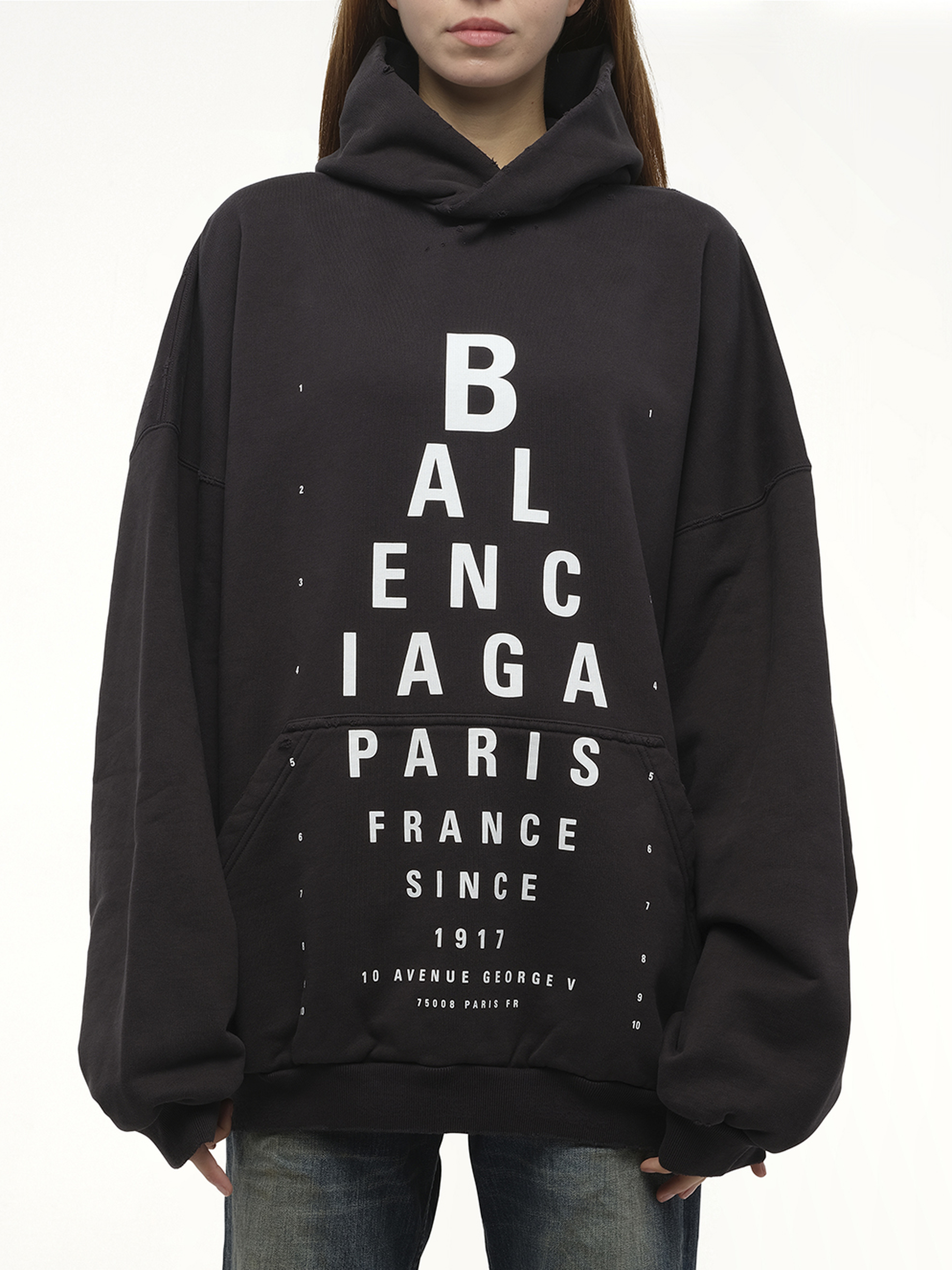 Image of a model wearing Outerwear. Productname: BALENCIAGA Eye-Test Large Fit Hoodie in Black colour by brand - BALENCIAGA