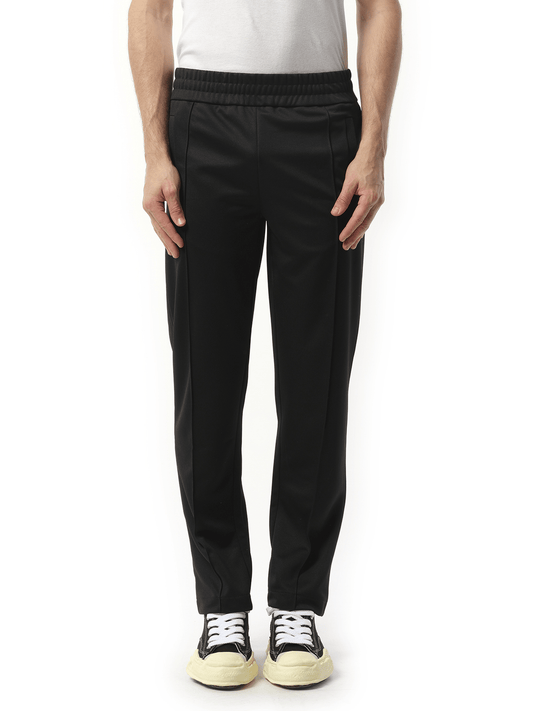 Image of a model wearing Pants. Productname: PALM ANGELS Back Curved Logo Track Pants in BLACK colour by brand - PALM ANGELS