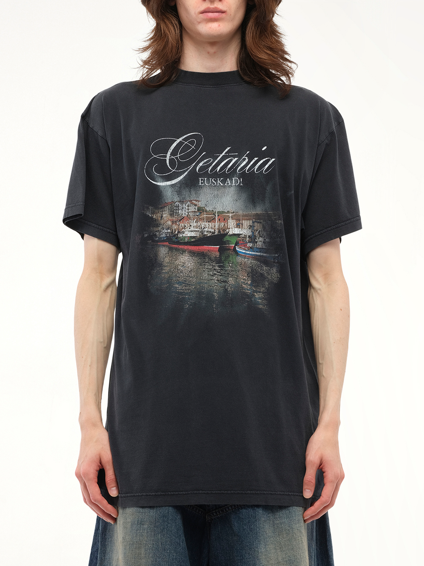 Image of a model wearing Tops. Productname: BALENCIAGA Getaria Oversized T-Shirt in Black colour by brand - BALENCIAGA