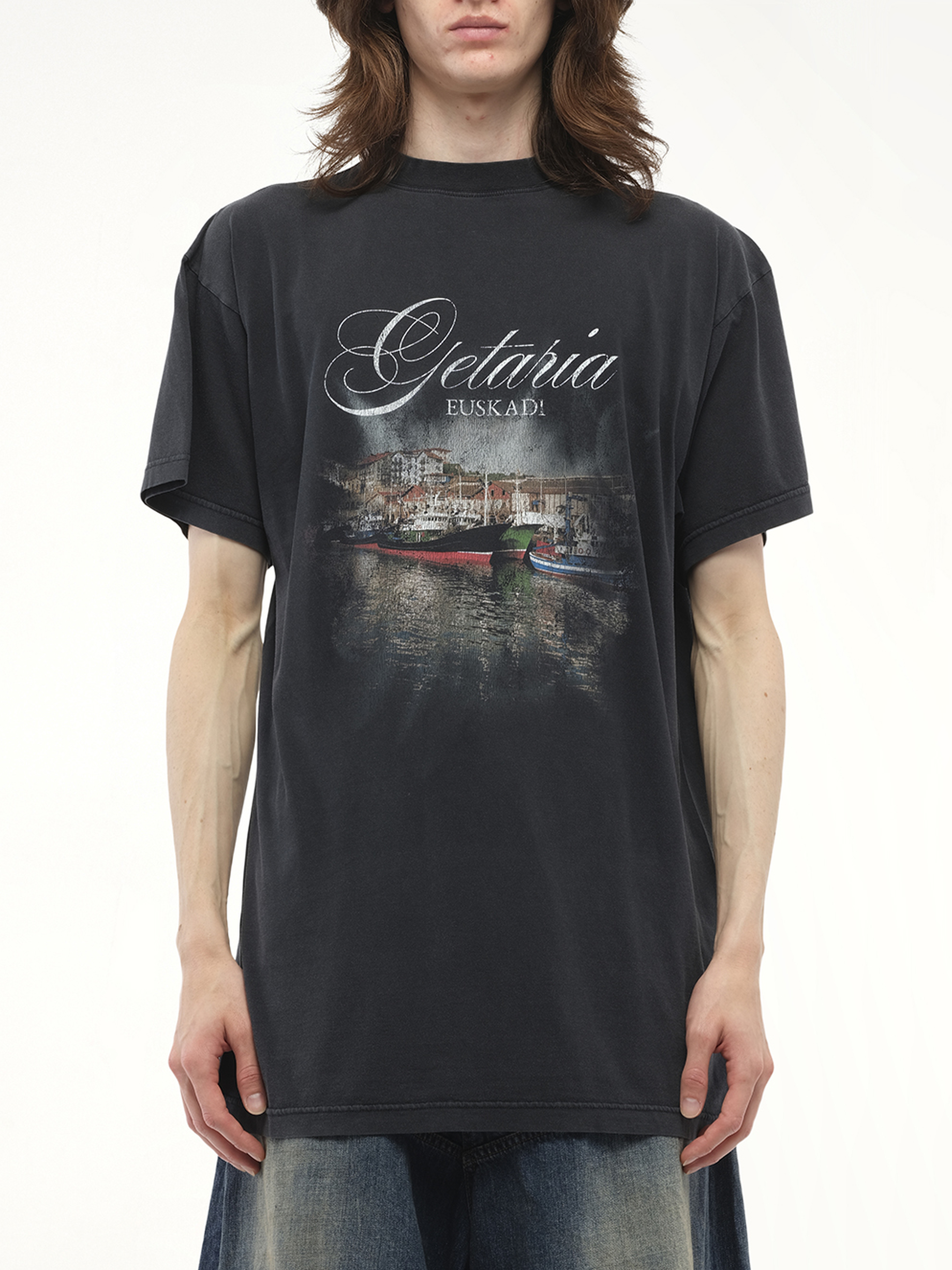 Image of a model wearing Tops. Productname: BALENCIAGA Getaria Oversized T-Shirt in Black colour by brand - BALENCIAGA