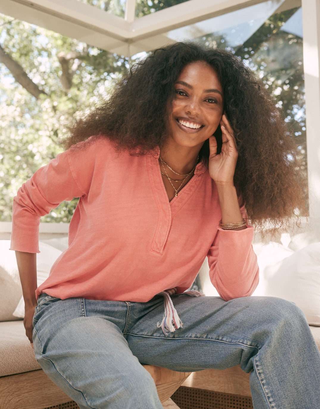Image of a model wearing Tops. Productname: Henley Sunset Top - in Melon colour by brand - White & Co.