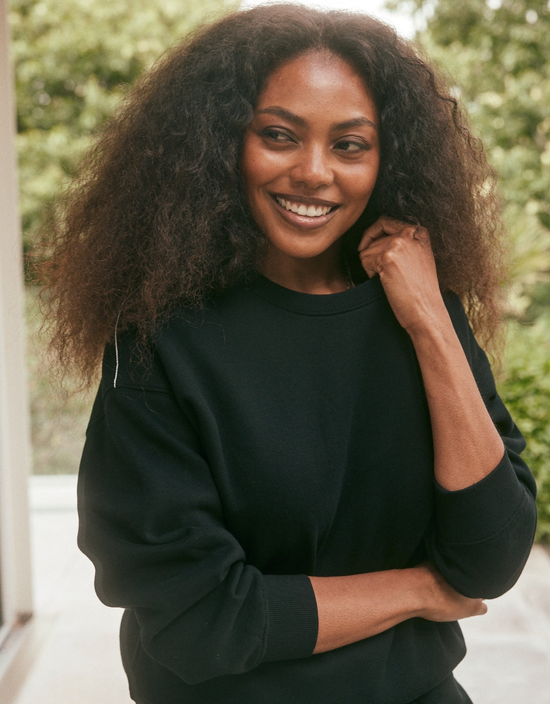 Image of a model wearing Tops. Productname: The Monogram Lounger Fleece Crew - in Black colour by brand - White & Co.