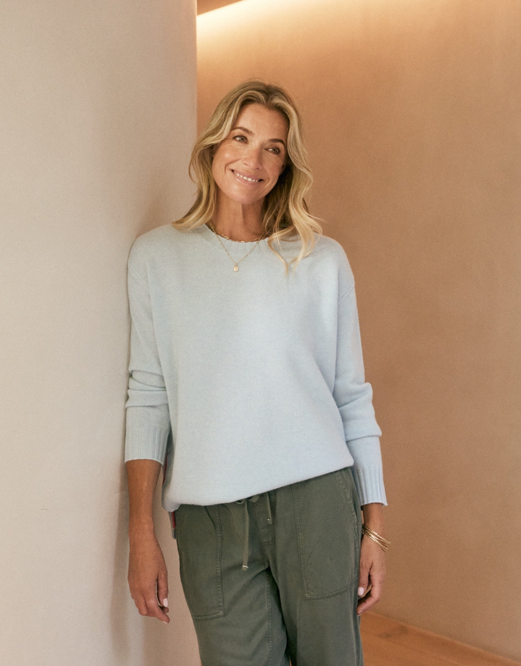 Image of a model wearing Outerwear. Productname: Saint Germain Wool Cashmere Scoop Hem Knit - in Ice Blue colour by brand - White & Co.