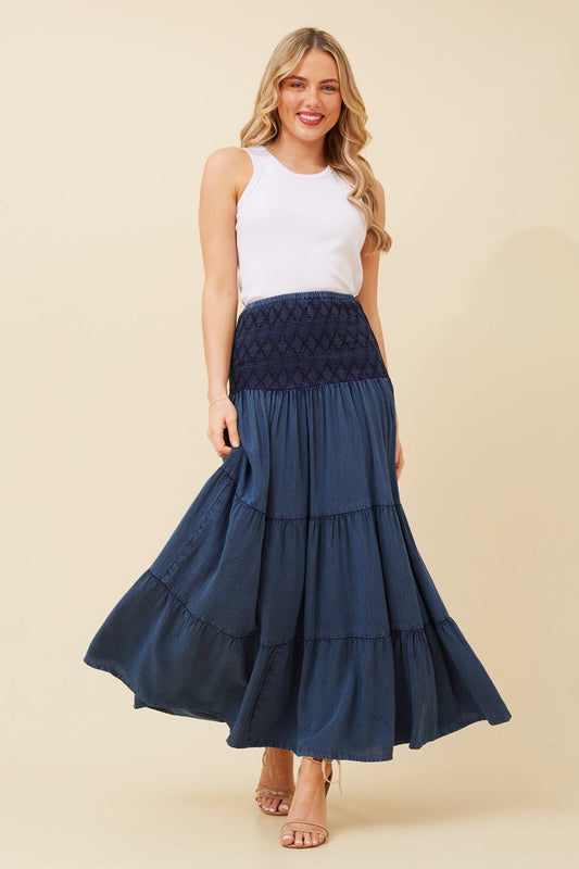 Image of a model wearing Skirts. Product name - KINGLEY TIERED MAXI SKIRT in Indigo colour by brand - Caroline Morgan Australia