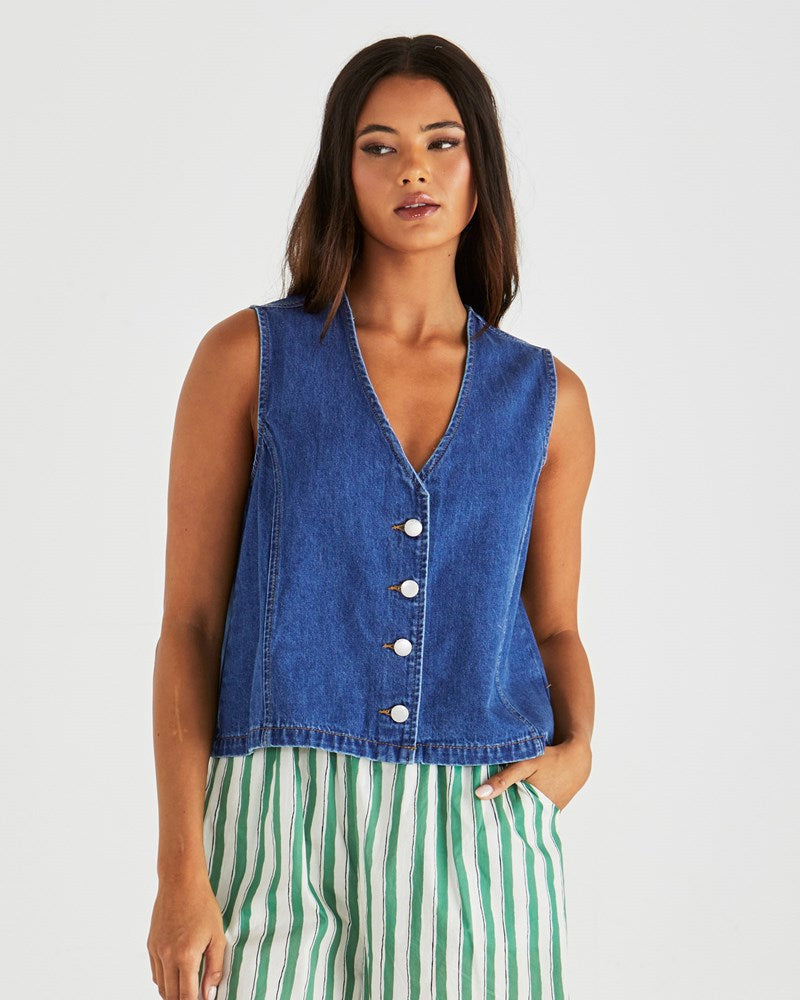 Image of a model wearing Tops. Product name - Sabine Denim Vest Mid Blue Wash in Mid Blue Wash colour by brand - Sass Clothing