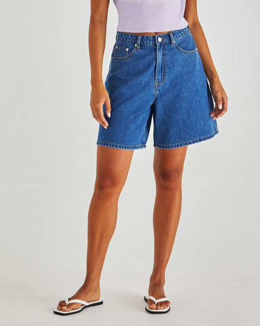 Image of a model wearing Shorts. Product name - Sabine Denim Shorts Mid Blue Wash in Mid Blue Wash colour by brand - Sass Clothing