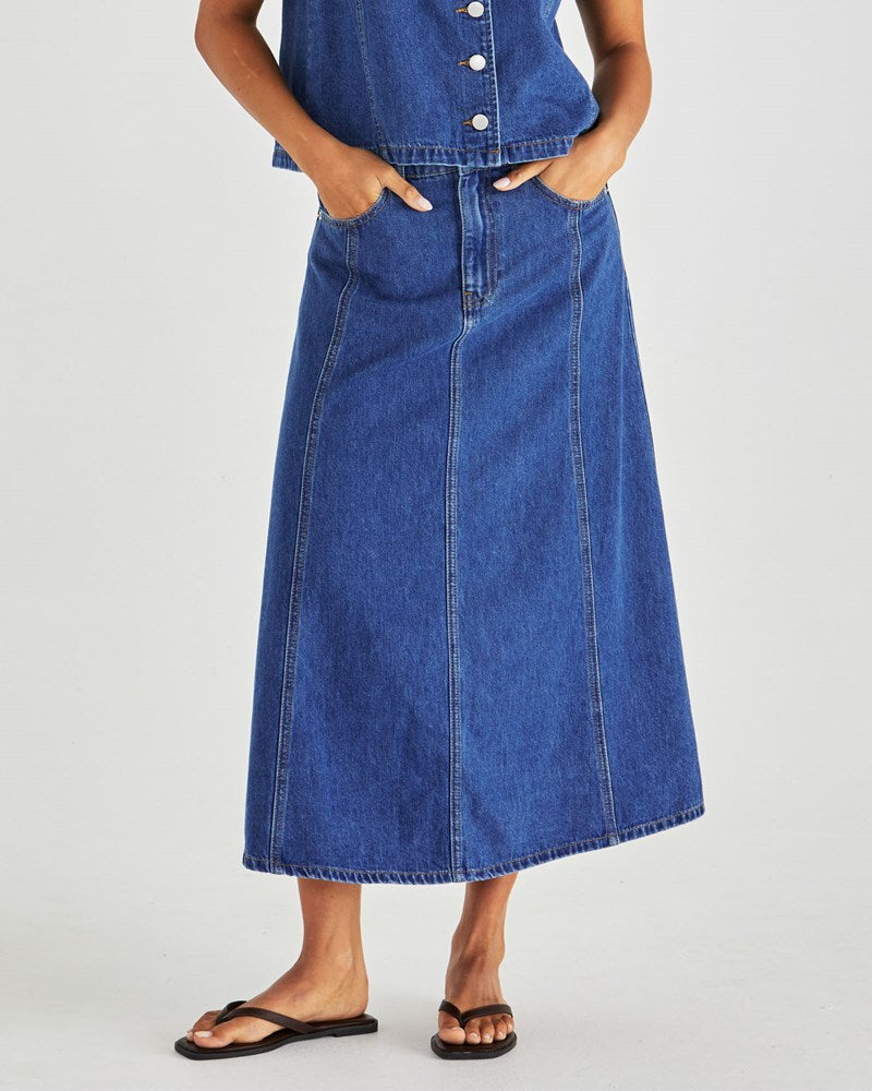 Image of a model wearing Skirts. Product name - Sabine Denim Skirt- Mid Blue Wash in Mid Blue Wash colour by brand - Sass Clothing