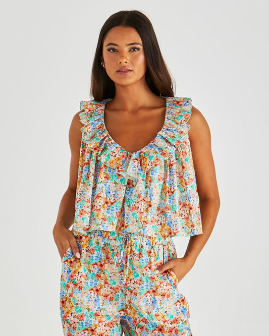 Image of a model wearing Tops. Product name - Panna Ruffled Neck Tank Blossom in Blossom colour by brand - Sass Clothing