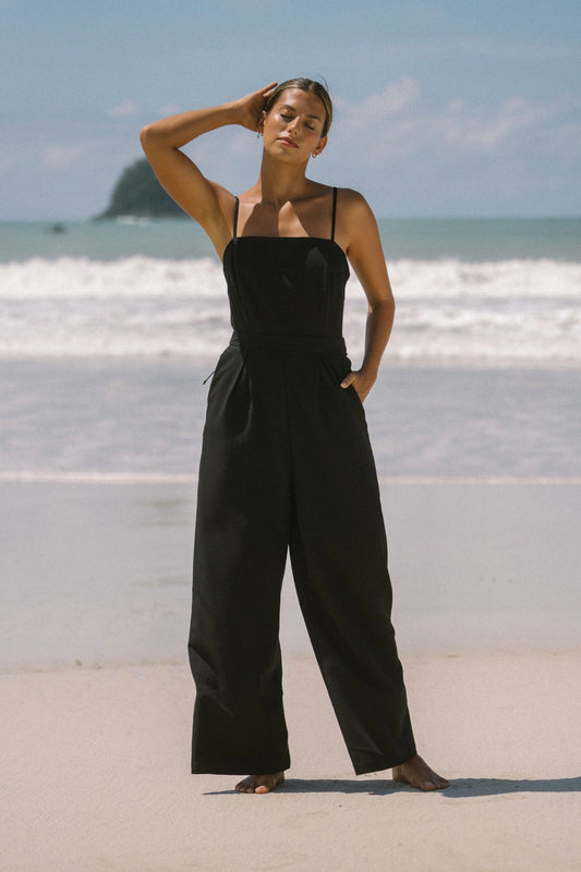 Image of a model wearing Outerwear. Productname: Heychic Estelle Black Tie Back Jumpsuit in Black colour by brand - Heychic