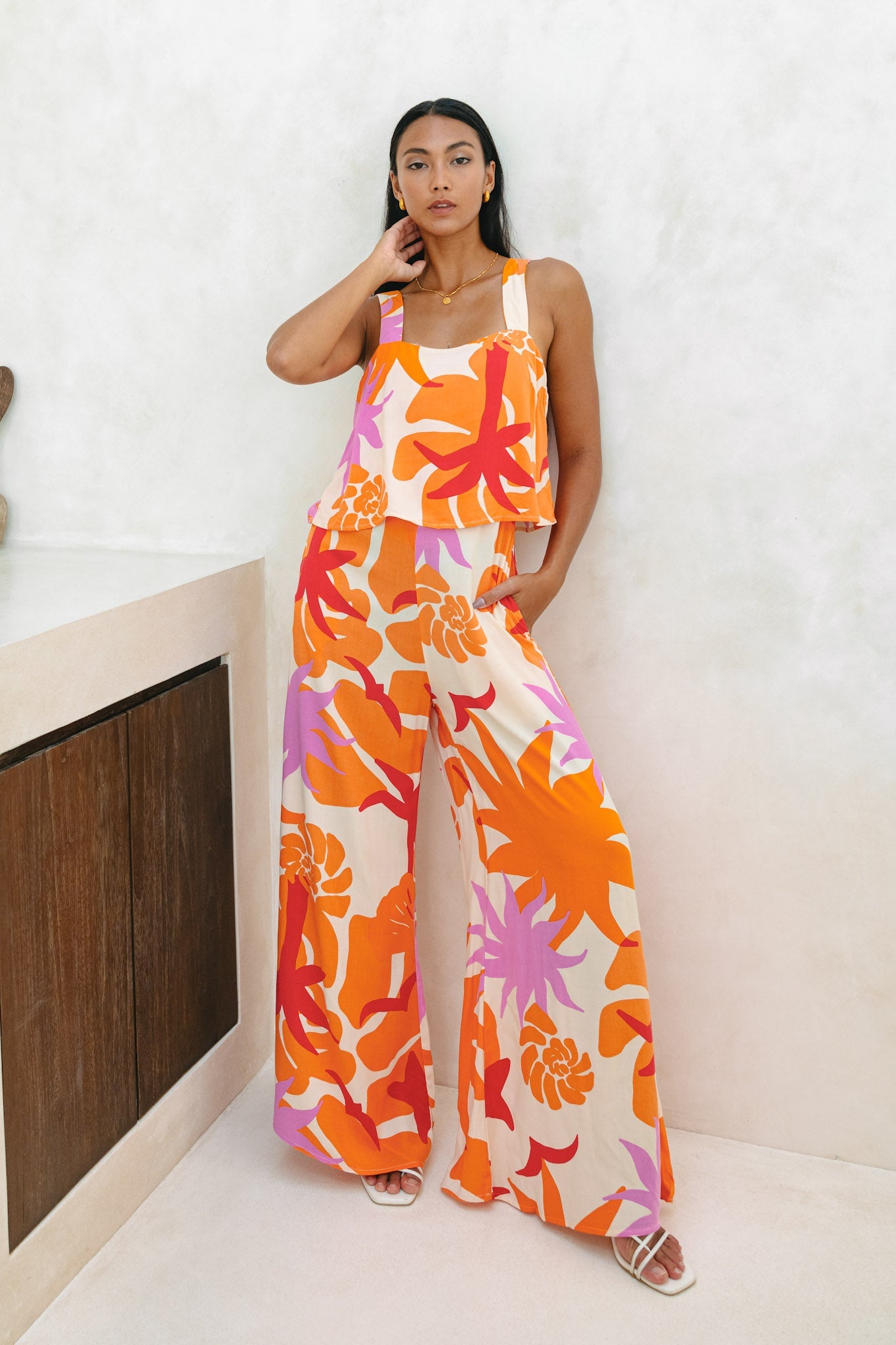 Image of a model wearing Outerwear. Productname: Heychic Calinda Orange Abstract Jumpsuit in Orange colour by brand - Heychic