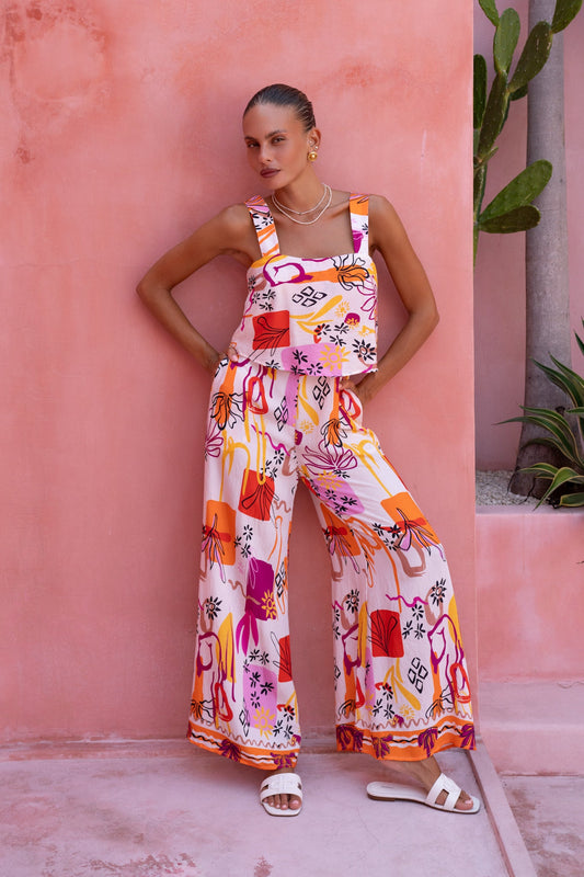 Image of a model wearing Outerwear. Productname: Heychic Saffron Abstract Jumpsuit in Orange colour by brand - Heychic