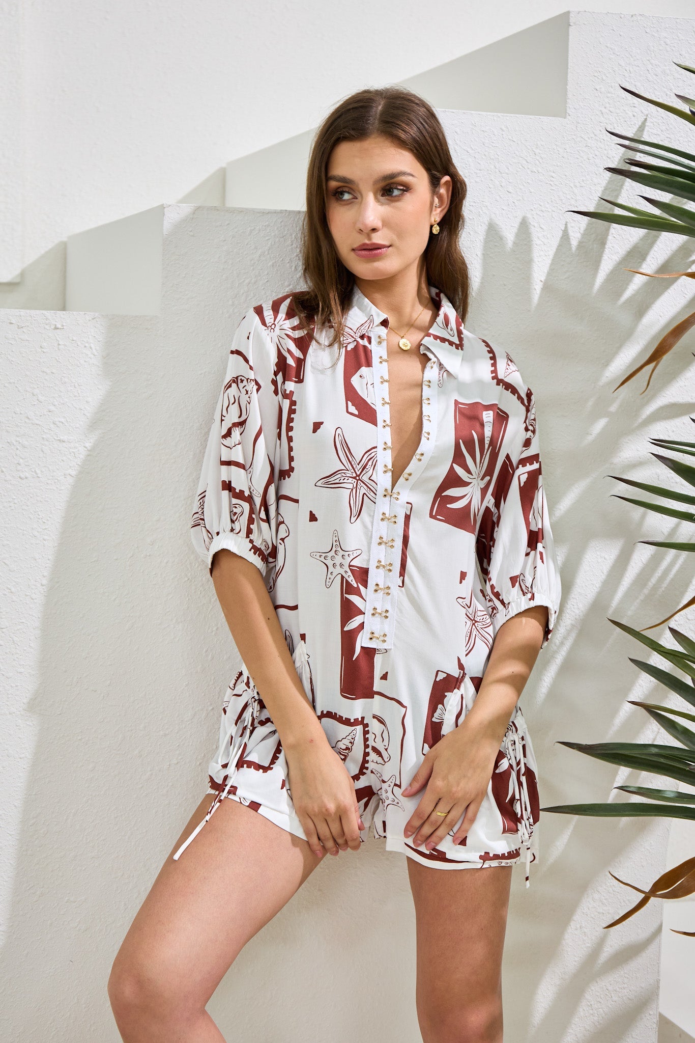 Image of a model wearing Outerwear. Productname: Heychic Mira Sea Shells Tropical Playsuit in Brown colour by brand - Heychic